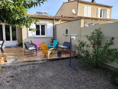 a group of chairs sitting on a wooden deck at escapade près du lac in Peyriac-de-Mer