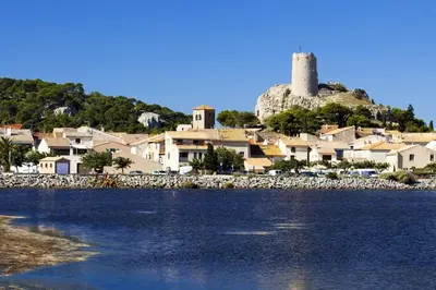 a view of a town with a castle on a hill at L'Escapade : Charmant T2 -Parking gratuit, piscine, wifi, clim in Gruissan