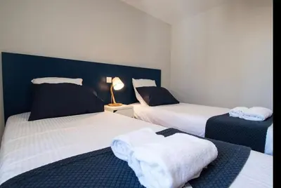 a room with two beds with towels on them at Le Saint Gimer - Vue sur la Cité Médiévale - Climatisation in Carcassonne