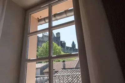 an open window with a view of a city at Le Saint Gimer - Vue sur la Cité Médiévale - Climatisation in Carcassonne