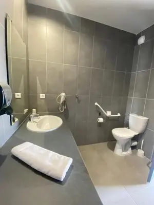 a bathroom with a white toilet and a sink at Douce France in Cuxac-dʼAude