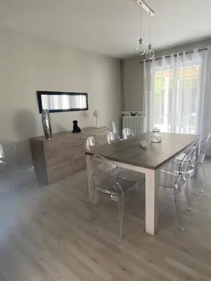 a dining room with a wooden table and chairs at Vue sur Cité - SPA in Carcassonne