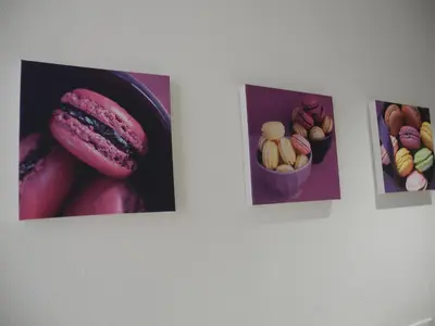 three pictures of food on a wall at Vue sur Cité - SPA in Carcassonne