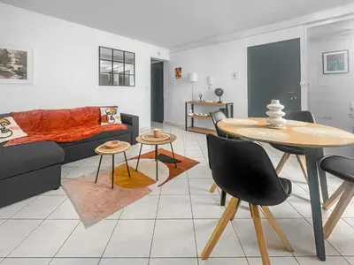a living room with a couch and a table at Le Petit Paradis de Carcassonne in Carcassonne
