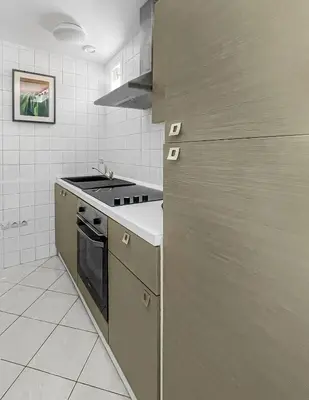 a kitchen with a sink and a stove top oven at Le Petit Paradis de Carcassonne in Carcassonne