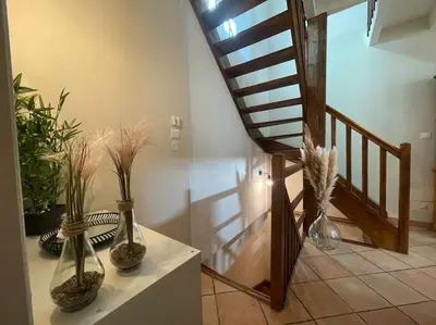 three vases sitting on a table next to a staircase at La Traverse - au pied de la Cité Médiévale - Clim et terrasse in Carcassonne