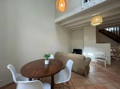 a living room with a table and a couch at La Traverse - au pied de la Cité Médiévale - Clim et terrasse in Carcassonne