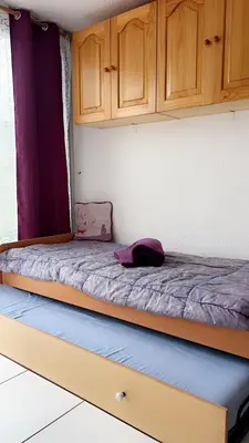 two beds in a room with wooden cabinets at La terrasse de Gruissan in Gruissan