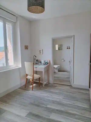 a room with a desk and a chair and a window at L'école buissonnière in Laroque-dʼOlmes