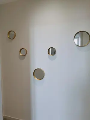a white wall with three lights on it at L'école buissonnière in Laroque-dʼOlmes
