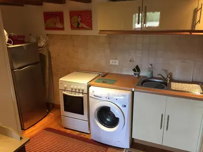 a kitchen with a washing machine and a sink at La Barthe Haute in Puycalvel Lautrec