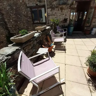 a group of chairs sitting on a patio at Les deux arches in Caunes-Minervois