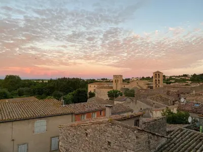 a view of a city at sunset at Les deux arches in Caunes-Minervois