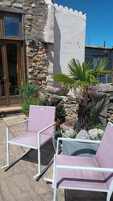 two chairs sitting in front of a building at Les deux arches in Caunes-Minervois