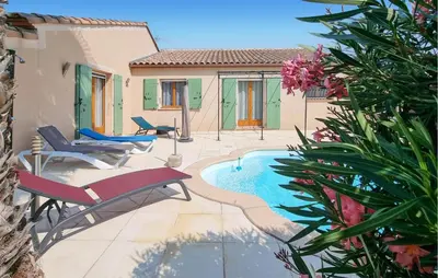 a patio with a pool and chairs and a house at Pet Friendly Home In Pouzols-Minervois in Pouzols-Minervois