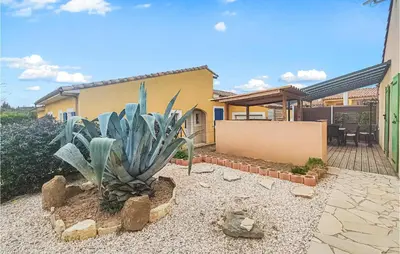 a house with a large plant in the yard at Pet Friendly Home In Pouzols-Minervois in Pouzols-Minervois