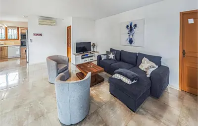a living room with a blue couch and chairs at Pet Friendly Home In Pouzols-Minervois in Pouzols-Minervois