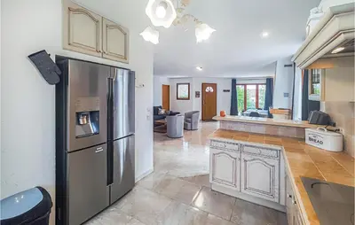 a kitchen with a stainless steel refrigerator in a room at Pet Friendly Home In Pouzols-Minervois in Pouzols-Minervois
