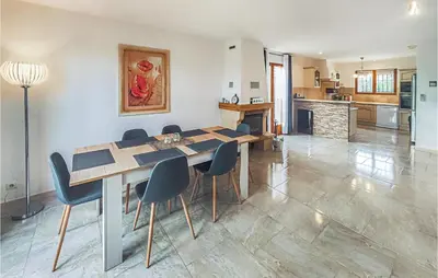 a kitchen and dining room with a table and chairs at Pet Friendly Home In Pouzols-Minervois in Pouzols-Minervois