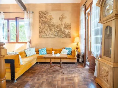a living room with a yellow couch with blue pillows at Tranquil Villa, Nature s Embrace in Cazouls-lès-Béziers