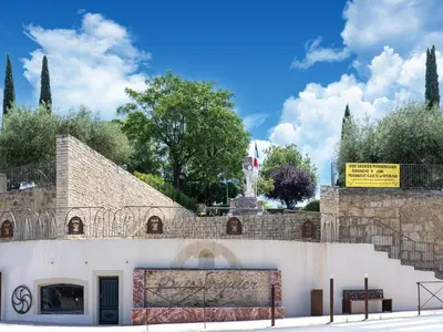 a building with a sign on the side of it at Tranquil Villa, Nature s Embrace in Cazouls-lès-Béziers