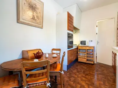a kitchen with a table and chairs in a room at Tranquil Villa, Nature s Embrace in Cazouls-lès-Béziers
