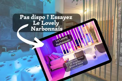 a tablet screen showing a room with a couch at Le Lovely Gruissanais - Balneo & Sauna in Gruissan