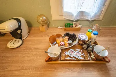 a table with a tray of food on a table at Le Lovely Gruissanais - Balneo & Sauna in Gruissan