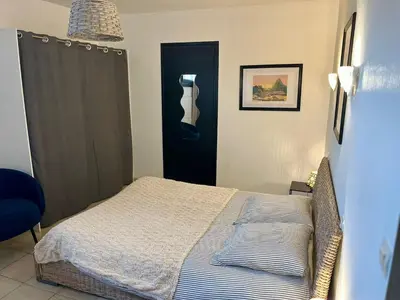 a bedroom with a bed and a black door at Grand et bel appartement classé 3 étoiles in Lavelanet