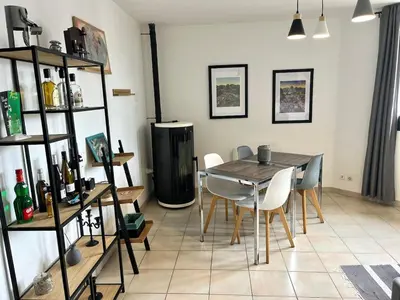 a dining room with a table and chairs at Grand et bel appartement classé 3 étoiles in Lavelanet