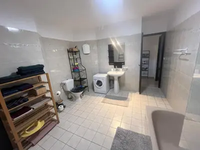 a bathroom with a sink and a toilet and a shower at Grand et bel appartement classé 3 étoiles in Lavelanet