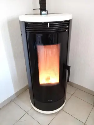 a black and white heater sitting on a tiled floor at Grand et bel appartement classé 3 étoiles in Lavelanet