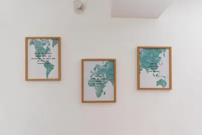 four framed maps of the world on a white wall at Les studios Jean Bringer - Carcassonne centre-ville in Carcassonne