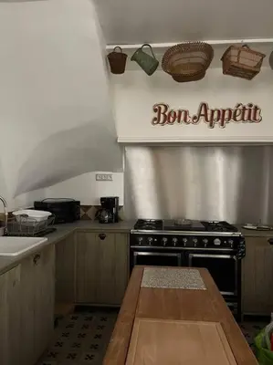 a kitchen with a stove and a counter top at Magnifique villa 11 couchages in Narbonne