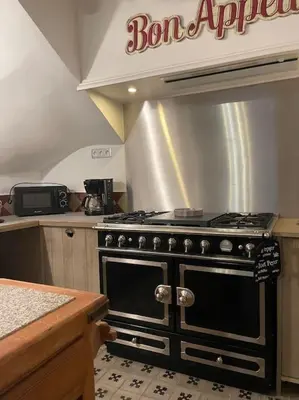 a kitchen with a black stove top oven at Magnifique villa 11 couchages in Narbonne