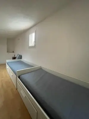 a bedroom with a large bed in a white wall at Magnifique villa 11 couchages in Narbonne
