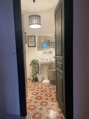 a bathroom with a sink and a toilet in a room at Magnifique villa 11 couchages in Narbonne