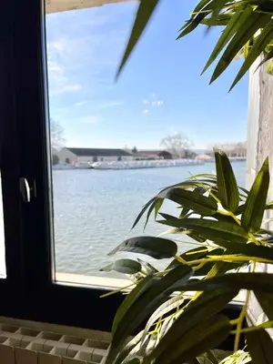 a window with a view of a body of water at Le bassin - Vue canal du midi avec climatisation et garage in Castelnaudary