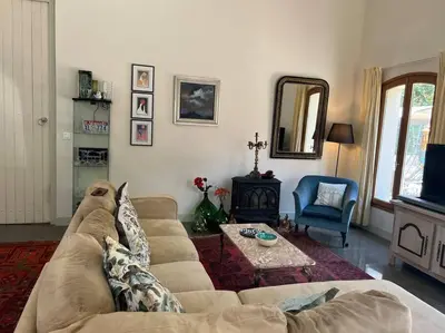 a living room with a couch and a table at The hat factory in Espéraza
