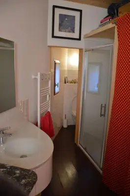 a bathroom with a toilet and a sink and a shower at Chalet, quiet, with view and pool (at summertime) in Ventenac-Cabardès