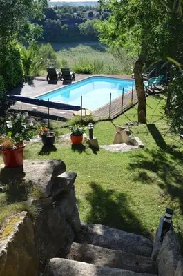a swimming pool in a yard with some plants at Chalet, quiet, with view and pool (at summertime) in Ventenac-Cabardès