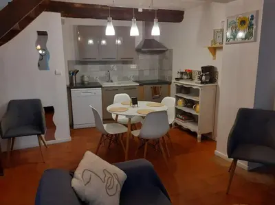a kitchen and dining room with a table and chairs at Maison chaleureuse près de lagrasse corbières in Saint-Pierre-des-Champs