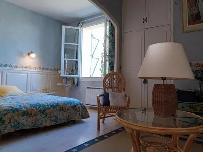 a bedroom with a bed and a glass table at Spacious holiday home with private pool and park in Puisserguier