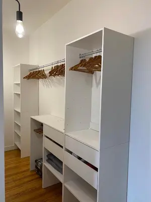 a white walk in closet with white cabinets at Chez Julie in Castres
