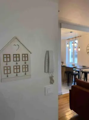 a house decoration hanging on a wall in a living room at Chez Julie in Castres
