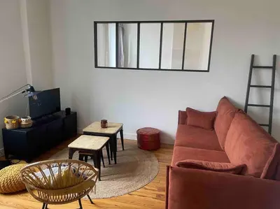 a living room with a couch and a table at Chez Julie in Castres