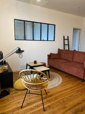 a living room with a couch and a chair at Chez Julie in Castres