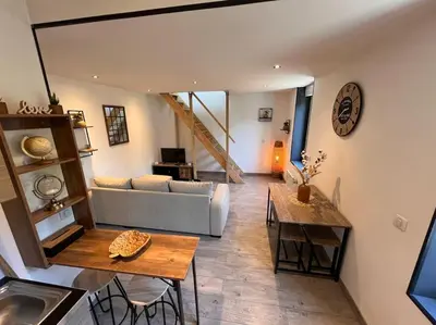 a living room with a couch and a table at Appartement Cosy à Narbonne in Narbonne