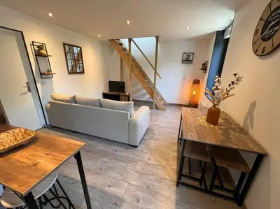 a living room with a couch and a table at Appartement Cosy à Narbonne in Narbonne