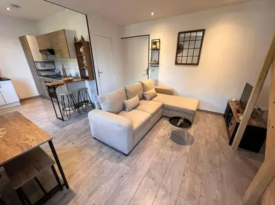 a living room with a couch and a table at Appartement Cosy à Narbonne in Narbonne